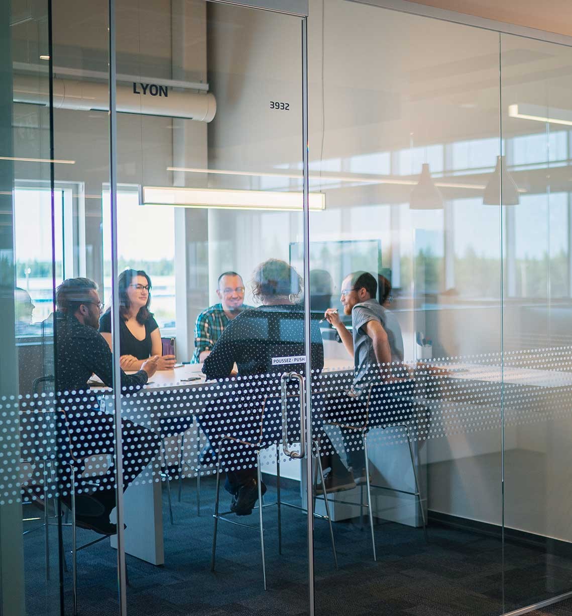 Team Members in a glass meeting room